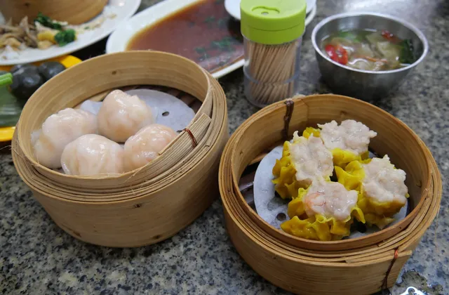 Shrimp dumplings and siu mai in two bamboo steamers