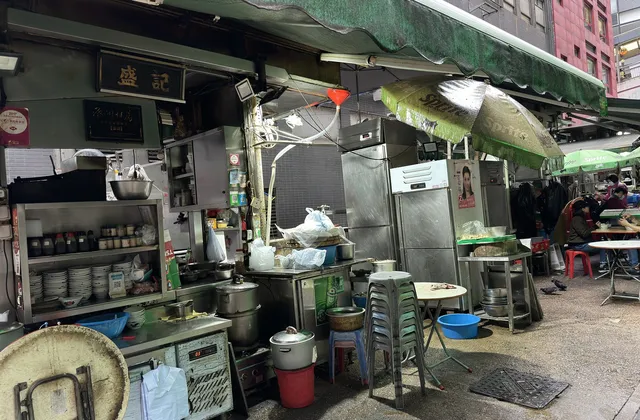 A dai pai dong kitchen on Stanley Street with steel counters, stools and green awnings