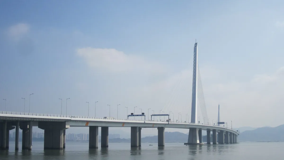The cable-stayed tower of the Shenzhen Bay Bridge rising above the water