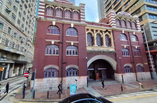 The red-brick Western Market building on a corner beside the tram tracks